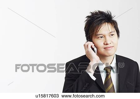 Stock Image - Businessman talking on a mobile phone. Fotosearch