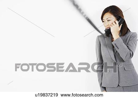 Stock Photo - Businesswoman talking on the telephone. Fotosearch