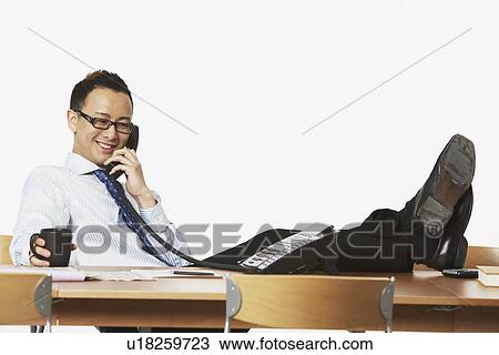 Stock Image - Close-up of a businessman talking on the telephone. Fotosearch