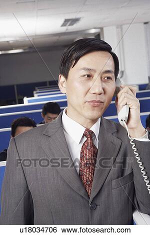 Stock Photograph - Close-up of a businessman talking on the telephone. Fotosearch