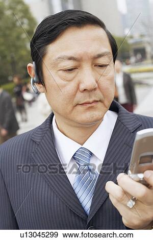 Close-up of a businessman using a mobile phone View Large Photo Image Stock Photo - Close-up of a businessman using a mobile phone. Fotosearch