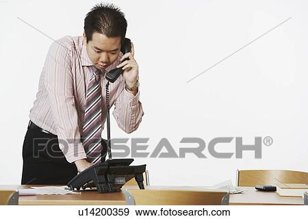 Close-up of a businessman using the telephone View Large Photo Image Stock Photo - Close-up of a businessman using the telephone. Fotosearch
