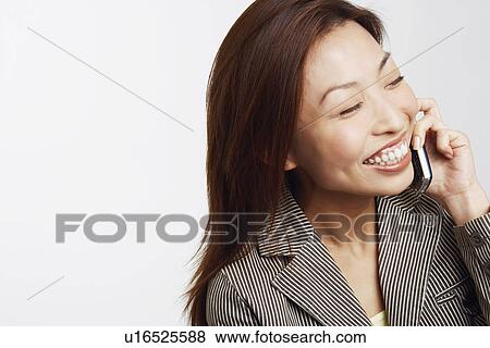 Close-up of a businesswoman talking on a mobile phone View Large Photo Image Stock Photo - Close-up of a businesswoman talking on a mobile phone. Fotosearch