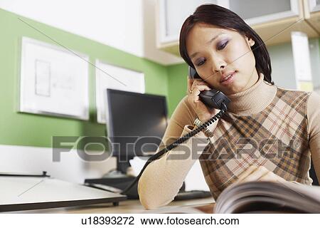 Close-up of a businesswoman using a telephone View Large Photo Image Stock Image - Close-up of a businesswoman using a telephone. Fotosearch