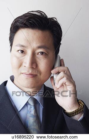 Portrait of a businessman talking on a mobile phone View Large Photo Image Stock Image - Portrait of a businessman talking on a mobile phone. Fotosearch