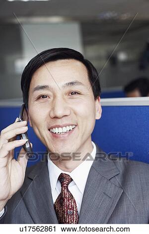 Stock Image - Portrait of a businessman talking on a mobile phone. Fotosearch
