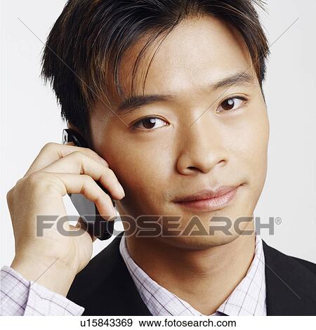 Portrait of a businessman talking on a mobile phone View Large Photo Image Stock Photo - Portrait of a businessman talking on a mobile phone. Fotosearch