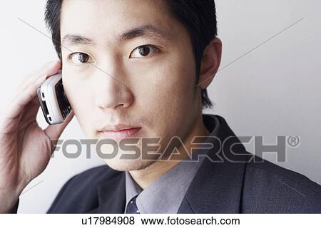 Portrait of a businessman talking on a mobile phone View Large Photo Image Stock Photo - Portrait of a businessman talking on a mobile phone. Fotosearch