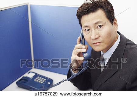 Stock Photo - Portrait of a businessman talking on the telephone. Fotosearch