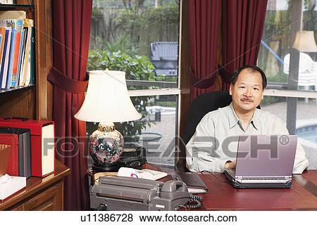 Portrait of a senior man using a laptop View Large Photo Image Stock Photo - Portrait of a senior man using a laptop. Fotosearch