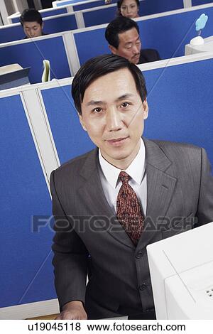 Stock Photo - Business executives working in an office. Fotosearch