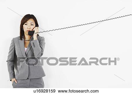 Stock Photo - Businesswoman talking on the telephone. Fotosearch