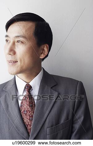 Close-up of a businessman looking sideways smiling View Large Photo Image Stock Photo - Close-up of a businessman looking sideways smiling. Fotosearch