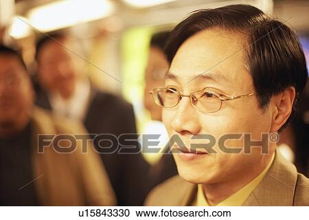 Close-up of a businessman smiling View Large Photo Image Stock Image - Close-up of a businessman smiling. Fotosearch