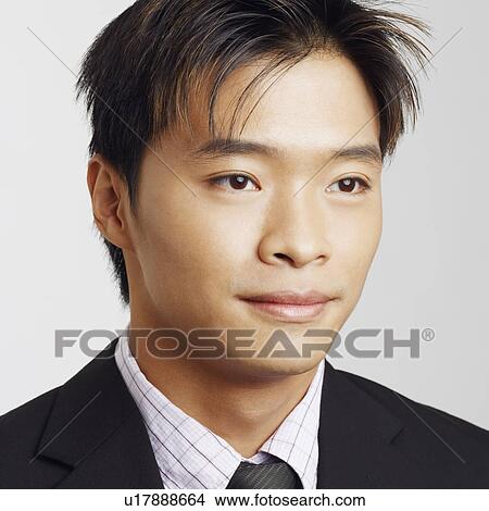 Picture - Close-up of a businessman smirking. Fotosearch
