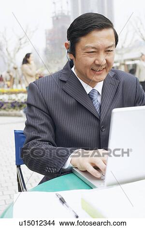 Close-up of a businessman using a laptop View Large Photo Image Picture - Close-up of a businessman using a laptop. Fotosearch