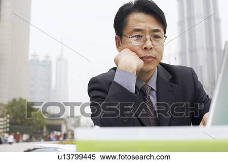 Stock Photography - Close-up of a businessman using a laptop. Fotosearch