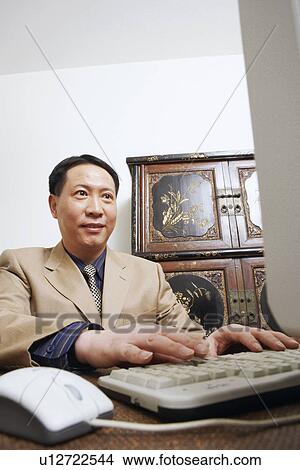 Close-up of a businessman using a computer View Large Photo Image Picture - Close-up of a businessman using a computer. Fotosearch