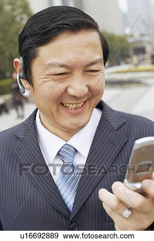 Close-up of a businessman using a mobile phone View Large Photo Image Stock Photo - Close-up of a businessman using a mobile phone. Fotosearch