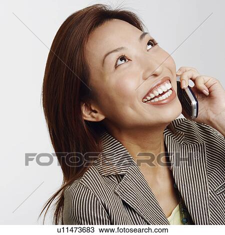 Stock Image - Close-up of a businesswoman talking on a mobile phone. Fotosearch