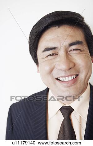Stock Image - Portrait of a businessman smiling. Fotosearch