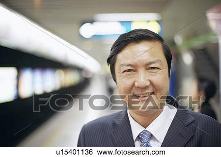 Stock Photograph - Portrait of a businessman smiling. Fotosearch