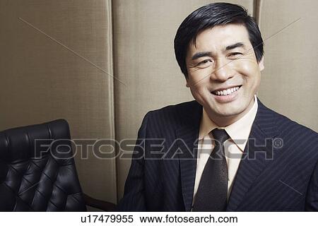 Portrait of a businessman smiling View Large Photo Image Stock Photography - Portrait of a businessman smiling. Fotosearch
