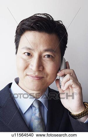 Portrait of a businessman talking on a mobile phone View Large Photo Image Stock Image - Portrait of a businessman talking on a mobile phone. Fotosearch