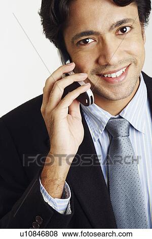 Portrait of a businessman talking on a mobile phone View Large Photo Image Stock Photo - Portrait of a businessman talking on a mobile phone. Fotosearch