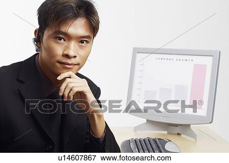 Stock Photo - Portrait of a businessman thinking in front of a progress report. Fotosearch