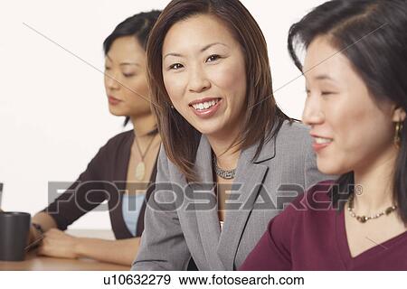 Portrait of a businesswoman sitting and smiling View Large Photo Image Stock Photo - Portrait of a businesswoman sitting and smiling. Fotosearch