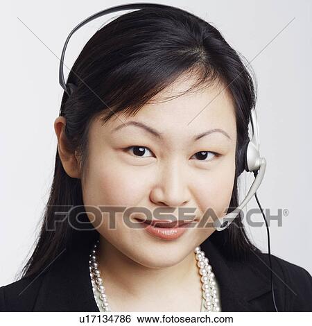 Stock Photograph - Portrait of a businesswoman wearing a headset. Fotosearch