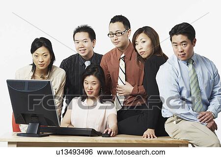 Portrait of a group of business executives in front of a computer View Large Photo Image Stock Photograph - Portrait of a group of business executives in front of a computer. Fotosearch