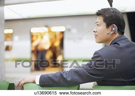 Side profile of a businessman wearing a hands free device View Large Photo Image Stock Photography - Side profile of a businessman wearing a hands free device. Fotosearch