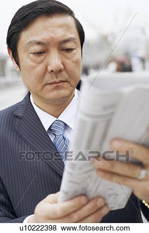 Close-up of a businessman reading a newspaper View Large Photo Image Stock Photo - Close-up of a businessman reading a newspaper. Fotosearch