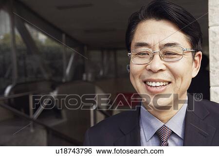 Stock Photograph - Close-up of a businessman smiling. Fotosearch