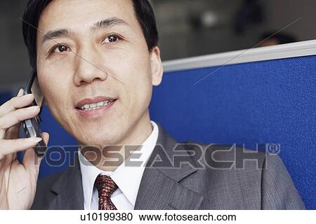 Close-up of a businessman talking on a mobile phone View Large Photo Image Stock Image - Close-up of a businessman talking on a mobile phone. Fotosearch