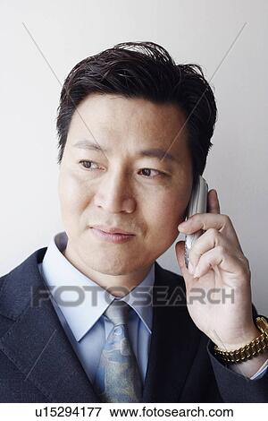 Stock Photo - Close-up of a businessman talking on a mobile phone. Fotosearch