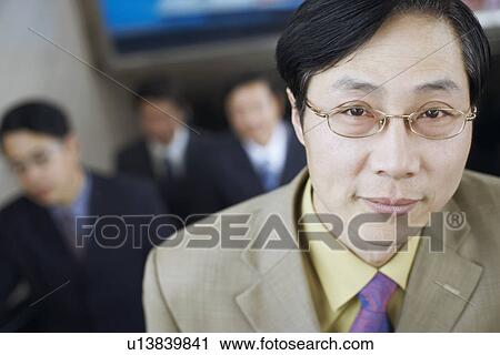 Stock Image - Portrait of a businessman on an escalator. Fotosearch