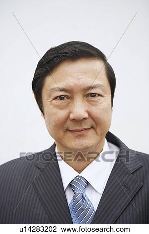 Stock Image - Portrait of a businessman smiling. Fotosearch