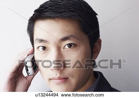Portrait of a businessman talking on a mobile phone View Large Photo Image Picture - Portrait of a businessman talking on a mobile phone. Fotosearch