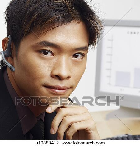 Stock Image - Portrait of a businessman thinking in front of a progress report. Fotosearch