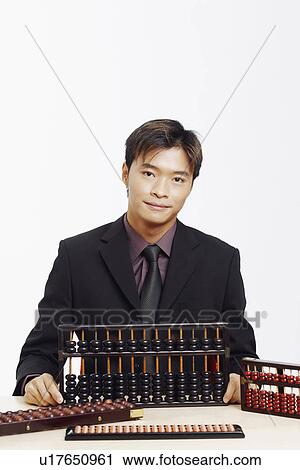 Portrait of a businessman with four abacuses View Large Photo Image Stock Image - Portrait of a businessman with four abacuses. Fotosearch