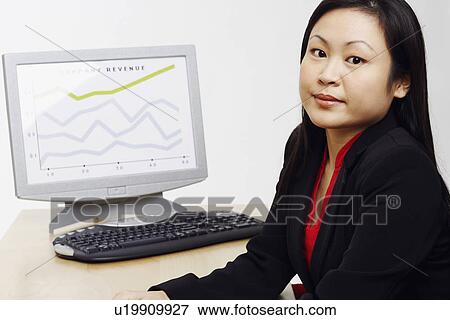 Stock Photo - Portrait of a businesswoman sitting with a progress report in the background. Fotosearch