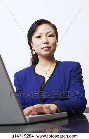 Portrait of a businesswoman using a laptop View Large Photo Image Picture - Portrait of a businesswoman using a laptop. Fotosearch