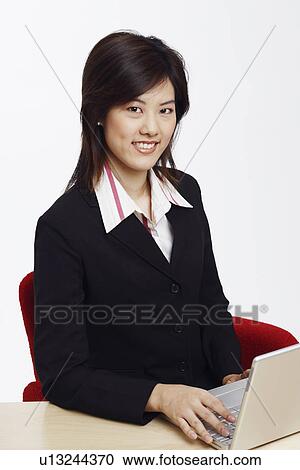 Stock Image - Portrait of a businesswoman using a laptop. Fotosearch
