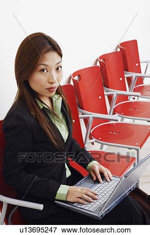 Stock Photo - Portrait of a businesswoman using a laptop. Fotosearch