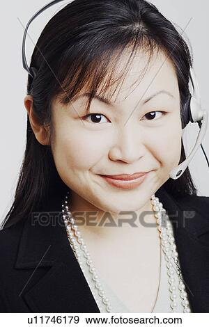 Portrait of a businesswoman wearing a headset View Large Photo Image Stock Photo - Portrait of a businesswoman wearing a headset. Fotosearch