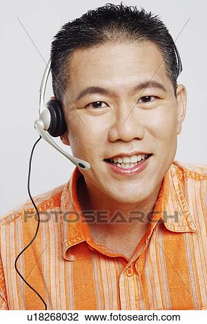 Portrait of a mid adult man wearing a headset and smiling View Large Photo Image Stock Image - Portrait of a mid adult man wearing a headset and smiling. Fotosearch