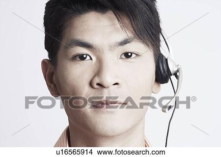 Portrait of a young man wearing a headset View Large Photo Image Picture - Portrait of a young man wearing a headset. Fotosearch
